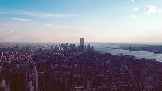 The New York City skyline as it appeared before September 11th, 2001, featuring the World Trade Center's Twin Towers on a clear day.