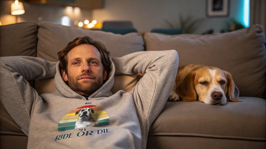 Man wearing hoodie leaning on couch where dog is napping - Doggo Mojo