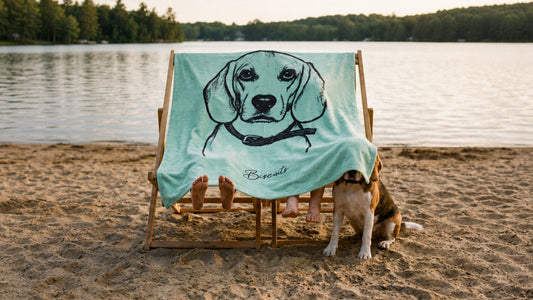 A child's tent formed by a luxuriously soft velveteen blanket draped over two chairs, its detailed design clearly visible. Include children's bare feet playfully peeking out and the lower half of a gentle beagle companion beside it.
