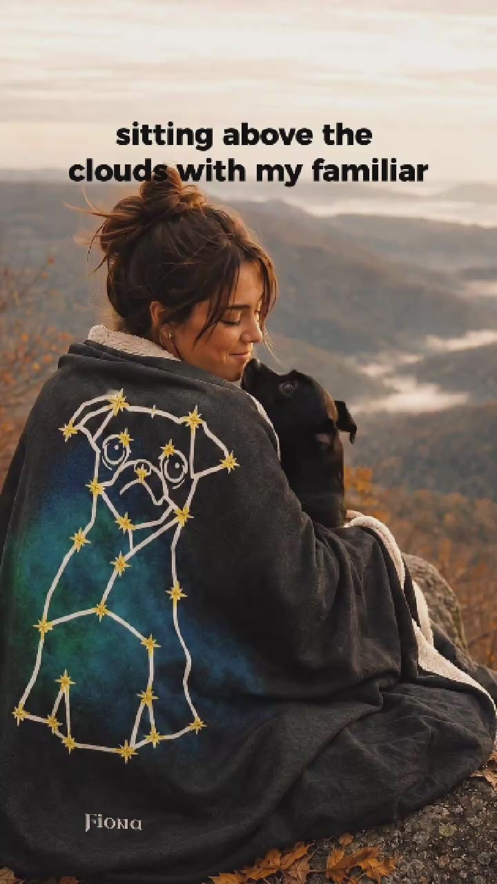 Girl sitting on an autumn mountain overlook with custom dog line-art sherpa fleece blanket draped over her shoulders, wrapped up with her dog receiving chin kisses.